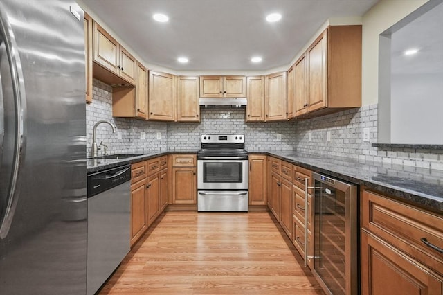 9 Broadway Unit 217, Saugus, MA 01906 - kitchen featuring beverage cooler, stainless steel appliances, under cabinet range hood, light wood finished floors, and a sink