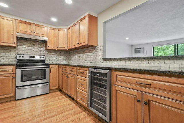 9 Broadway Unit 217, Saugus, MA 01906 - kitchen with wine cooler, stainless steel range with electric stovetop, under cabinet range hood, light wood-style flooring, and backsplash
