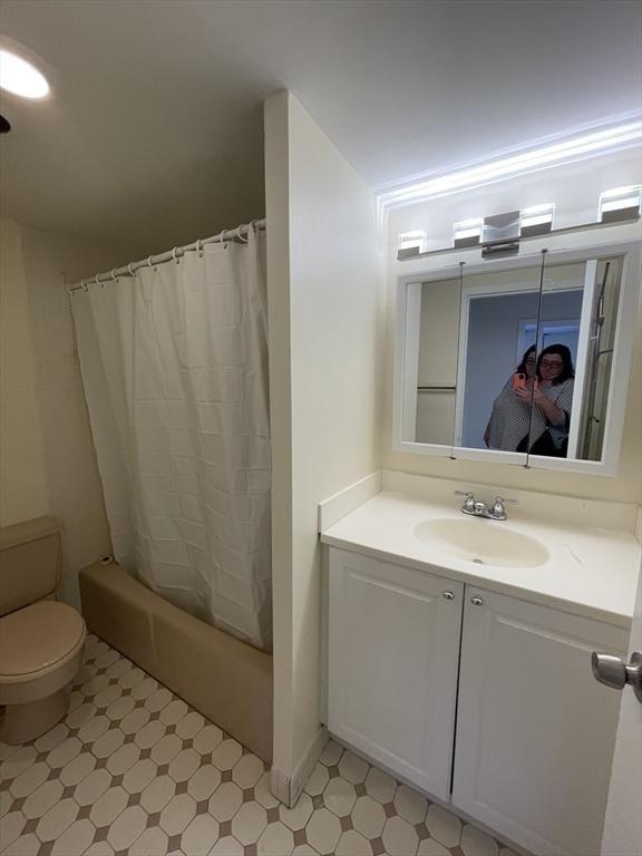 bathroom with toilet, shower / tub combo, vanity, and tile patterned floors