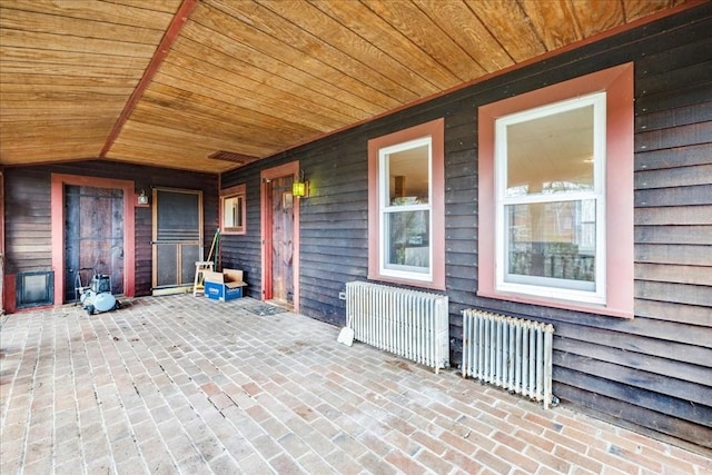view of patio / terrace with covered porch and radiator