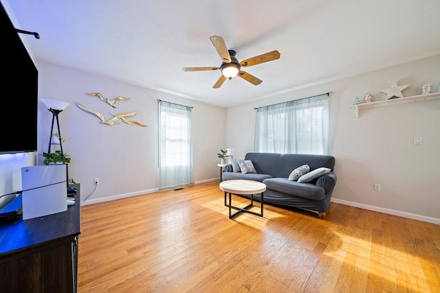 living room with ceiling fan and light wood-type flooring