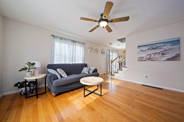 living room featuring hardwood / wood-style flooring and ceiling fan