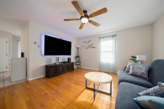 living room featuring ceiling fan and light hardwood / wood-style floors