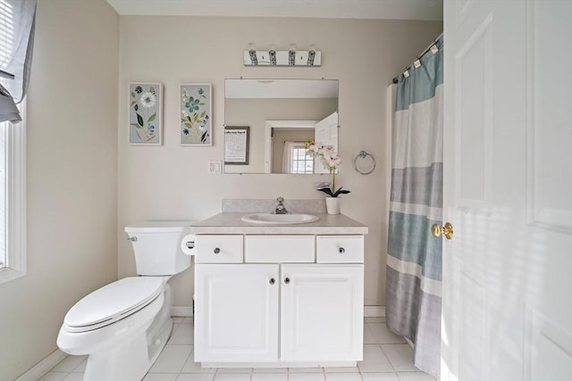 bathroom featuring tile patterned floors, vanity, and toilet