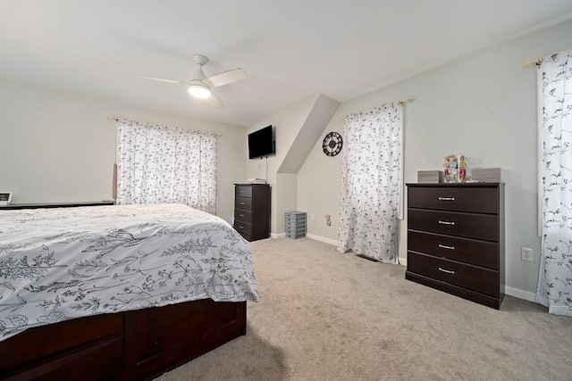 carpeted bedroom featuring multiple windows and ceiling fan