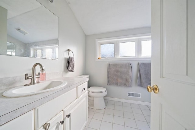 bathroom featuring tile patterned flooring, vanity, vaulted ceiling, and toilet