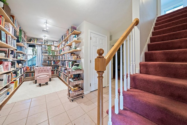 interior space with tile patterned floors and rail lighting