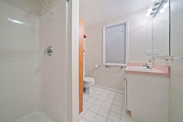 bathroom featuring tile patterned flooring, vanity, toilet, and walk in shower