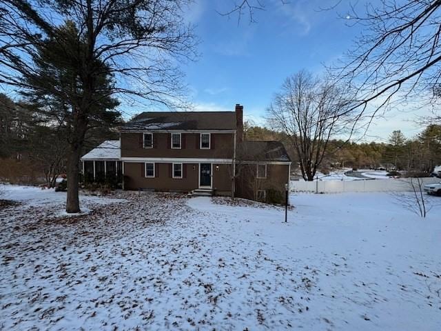 view of snow covered rear of property