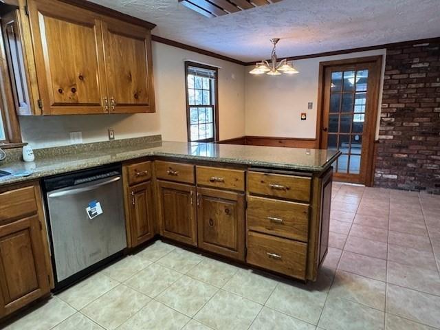 kitchen with decorative light fixtures, dishwasher, ornamental molding, kitchen peninsula, and a textured ceiling