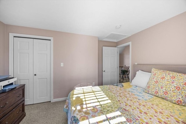 bedroom with baseboards, light carpet, a closet, and attic access