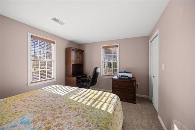 bedroom featuring visible vents, baseboards, and light colored carpet