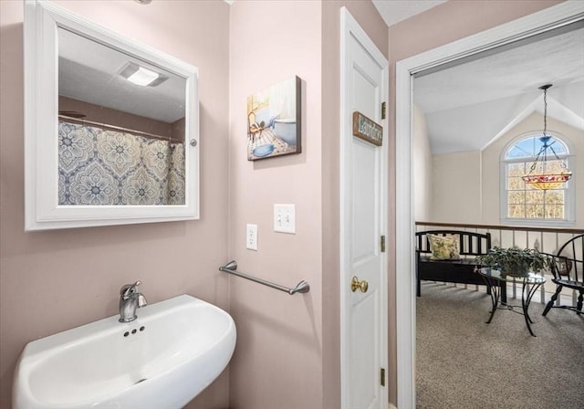 bathroom with a sink and vaulted ceiling