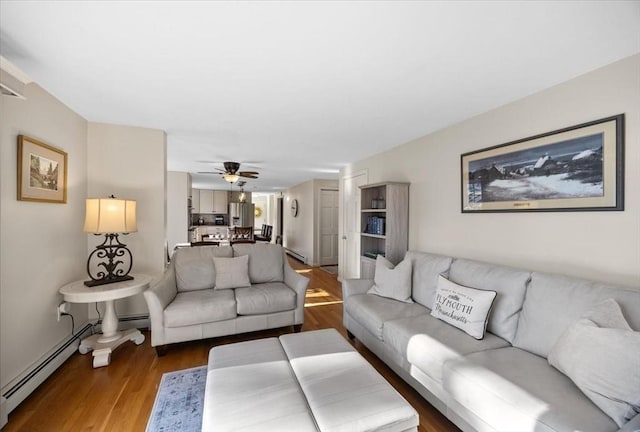 living room featuring a ceiling fan and light wood-style floors