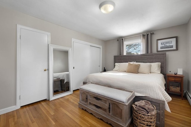 bedroom with light wood finished floors and a closet