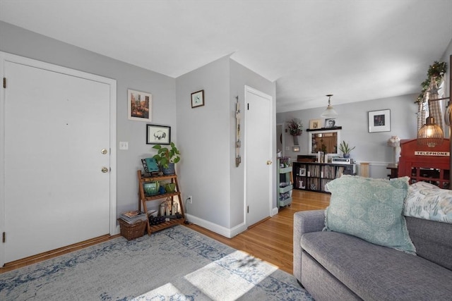 living area featuring baseboards and wood finished floors