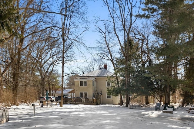 exterior space with a chimney and a wooden deck