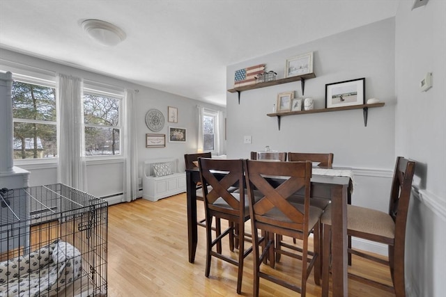 dining room featuring a baseboard radiator and light wood-style flooring