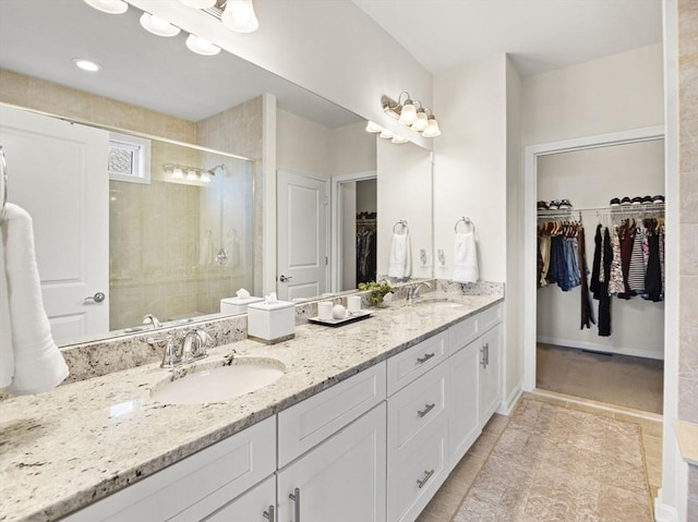 bathroom featuring an enclosed shower and vanity