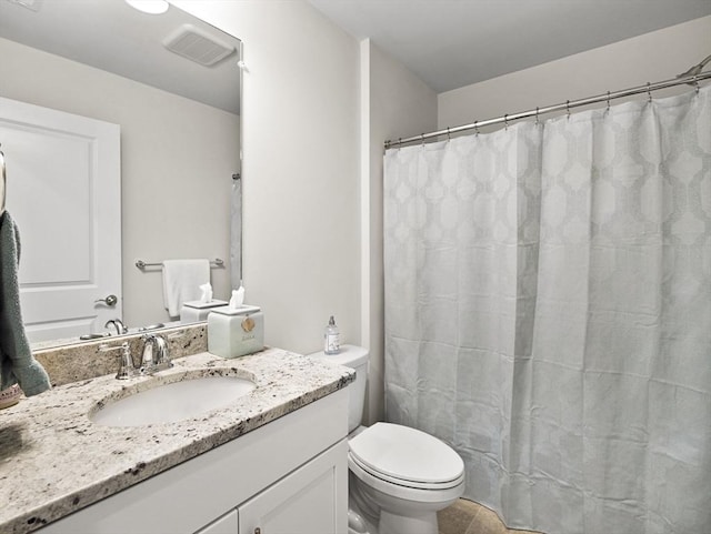 bathroom featuring toilet and vanity