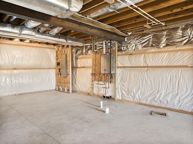 basement featuring water heater and electric panel