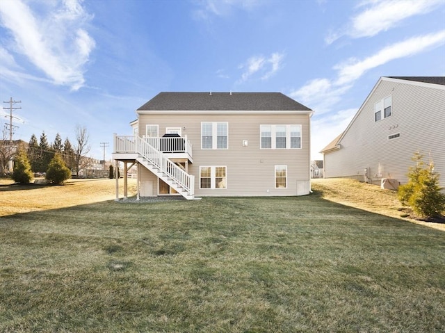 rear view of house featuring a deck and a yard