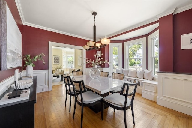 1 Murdock Ter, Boston, MA 02135 - dining room with healthy amount of natural light, a chandelier, a wainscoted wall, crown molding, and a decorative wall