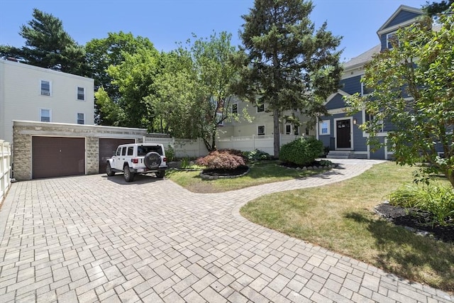 1 Murdock Ter, Boston, MA 02135 - view of front facade featuring decorative driveway, a garage, and stone siding