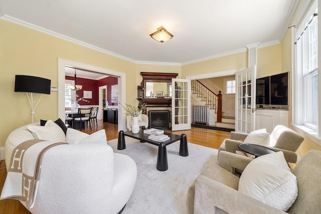 1 Murdock Ter, Boston, MA 02135 - living area featuring stairway, wood finished floors, crown molding, a chandelier, and a fireplace