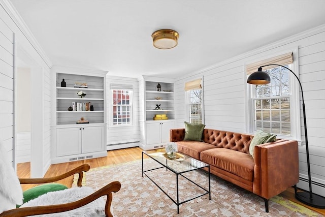 living room featuring crown molding, light wood-style flooring, visible vents, and baseboard heating