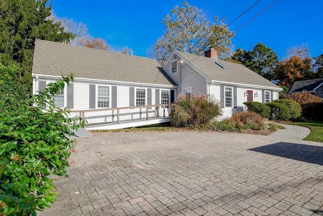 new england style home with a deck