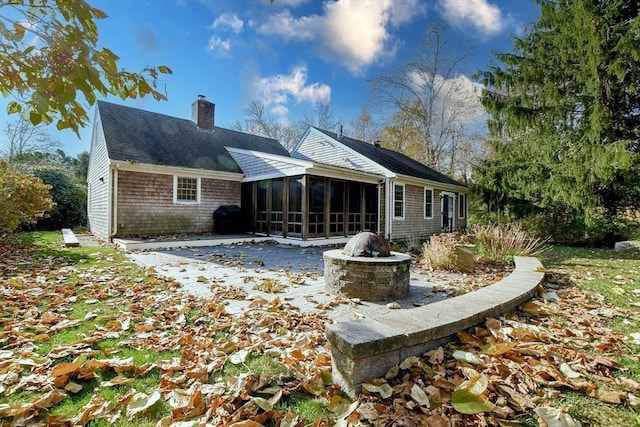 back of house featuring a sunroom and a patio area