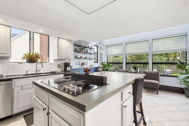 23 Mulholland Dr, Ipswich, MA 01938 - kitchen with stovetop with downdraft, dark countertops, a kitchen island, tasteful backsplash, and open shelves