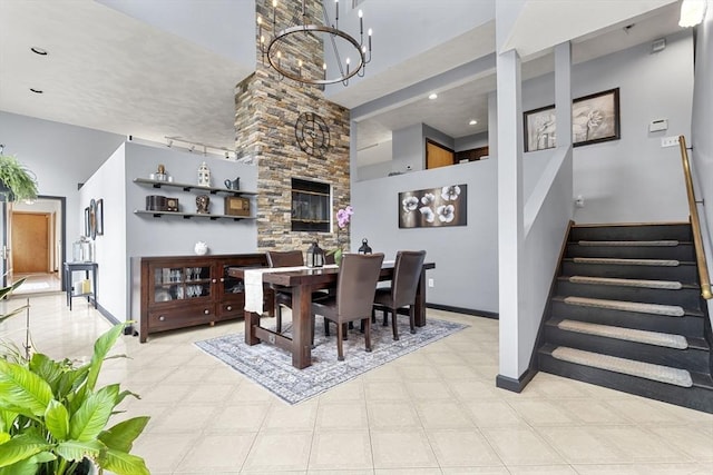 23 Mulholland Dr, Ipswich, MA 01938 - dining space featuring stairway, a chandelier, tile patterned floors, and a towering ceiling