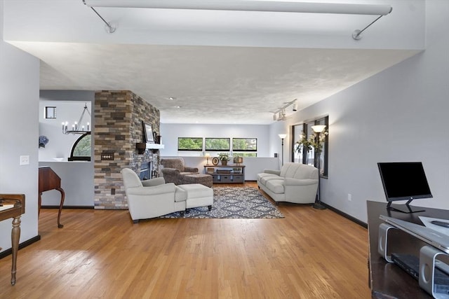 23 Mulholland Dr, Ipswich, MA 01938 - living area with rail lighting, wood finished floors, and a chandelier