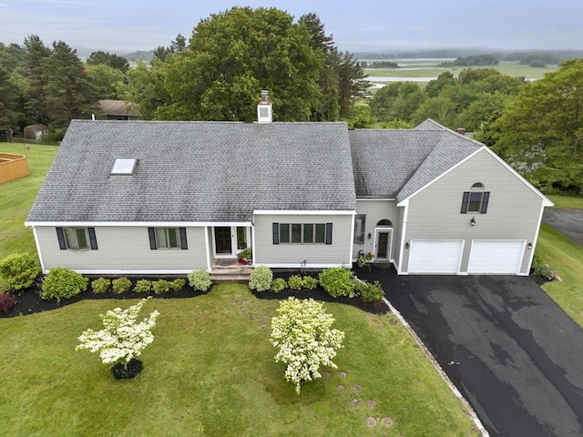 23 Mulholland Dr, Ipswich, MA 01938 - view of front of home featuring a chimney, a front yard, and driveway
