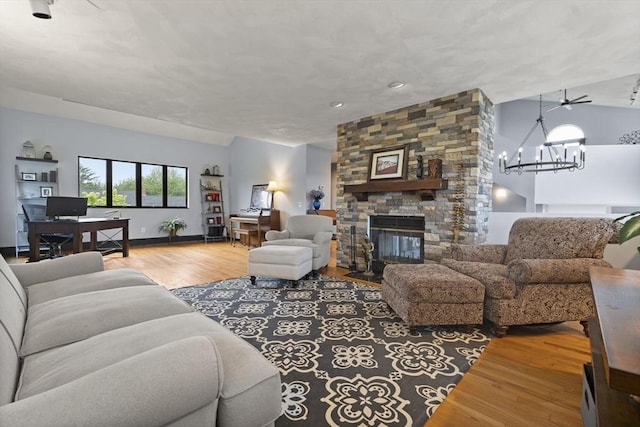23 Mulholland Dr, Ipswich, MA 01938 - living area with wood finished floors, a stone fireplace, a chandelier, and a desk