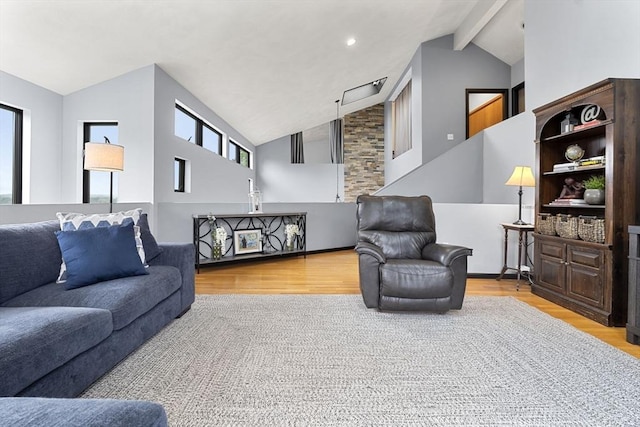 23 Mulholland Dr, Ipswich, MA 01938 - living area featuring wood finished floors, high vaulted ceiling, and beamed ceiling