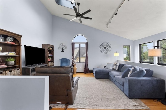 23 Mulholland Dr, Ipswich, MA 01938 - living area with lofted ceiling, wood finished floors, track lighting, and a ceiling fan
