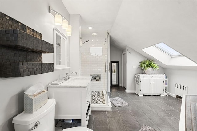23 Mulholland Dr, Ipswich, MA 01938 - full bath with a skylight, radiator heating unit, a stall shower, vaulted ceiling, and vanity