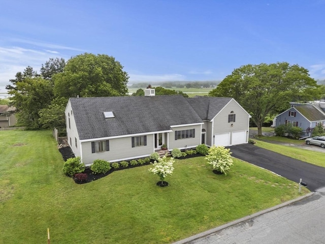 23 Mulholland Dr, Ipswich, MA 01938 - view of front of property with a front yard, driveway, roof with shingles, and an attached garage