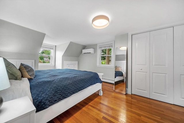 72 Marlboro St, Dedham, MA 02026 - bedroom with a wall mounted AC, light wood-type flooring, a baseboard radiator, multiple windows, and vaulted ceiling