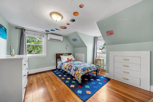 72 Marlboro St, Dedham, MA 02026 - bedroom featuring a wall unit AC, baseboard heating, light wood finished floors, and vaulted ceiling