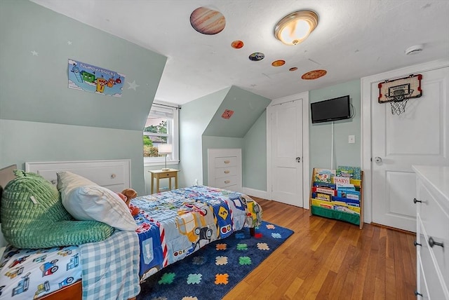 72 Marlboro St, Dedham, MA 02026 - bedroom featuring wood finished floors, vaulted ceiling, and a closet