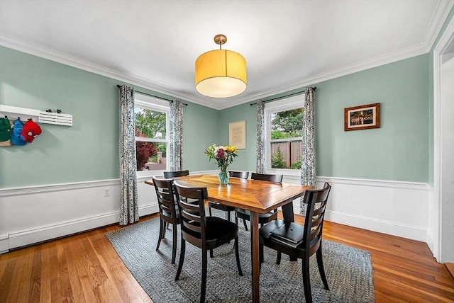 72 Marlboro St, Dedham, MA 02026 - dining space featuring ornamental molding, wood finished floors, wainscoting, and a baseboard radiator