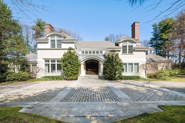 135 Marsh St, Belmont, MA 02478 - back of property with stucco siding and a chimney