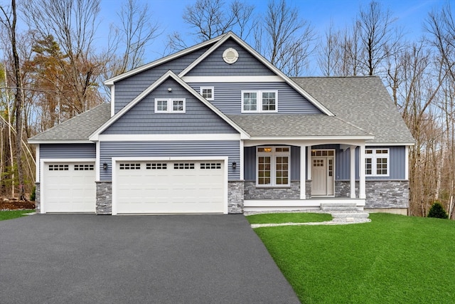 craftsman-style house featuring a garage and a front lawn