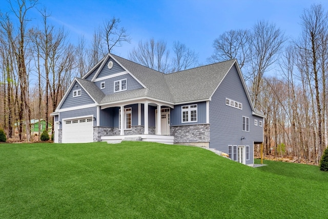 craftsman-style house with covered porch, a front yard, and a garage