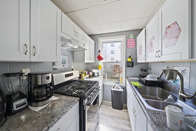 48 Rocliffe St, Fall River, MA 02723 - kitchen featuring stainless steel range with gas stovetop, under cabinet range hood, a sink, a paneled ceiling, and light wood-style flooring