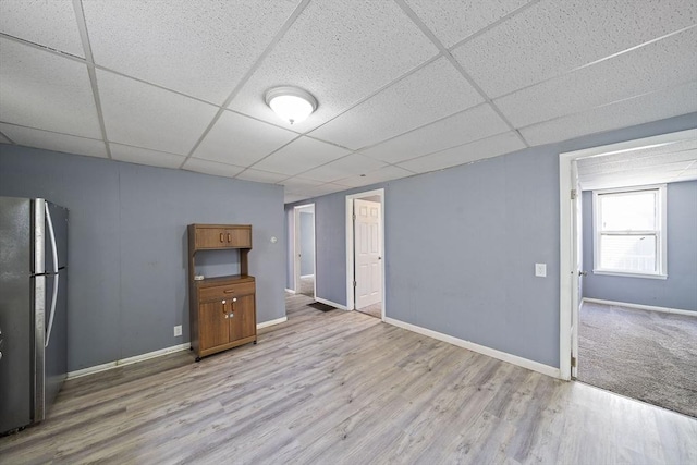 48 Rocliffe St, Fall River, MA 02723 - kitchen featuring freestanding refrigerator, a paneled ceiling, light wood-type flooring, baseboards, and brown cabinetry